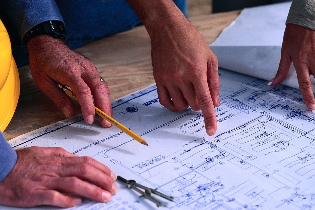 Photo of a people going over blueprints